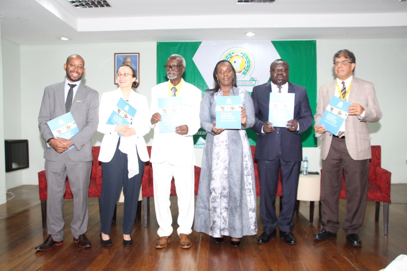 The Chairperson of the EAC Council of Ministers, Hon. Dr. Kirunda Kivejinja (third left), Rwandan Minister of Health Dr. Diane Gashumba (third right) and EAC Deputy Secretary General Christophe Bazivamo (second right) and other dignitaries pose with the 2nd EAC Regional Pharmaceutical Manufacturing Plan of Action 2017-2027 after its launch in Arusha.