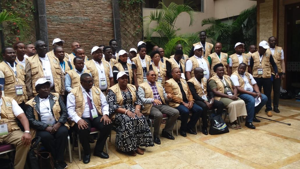 The Head of the EAC Election Observation Mission to Kenya, H.E. Dr. Jakaya Kikwete (seated, fifth right), in a group photo with EAC Election Observers shortly before he flagged off observation teams to the field. Flanking Dr. Kikwete are the Deputy Head of Mission, Hon. Fatuma Ndangiza (left) and EAC Secretary General Hon. Peter Mathuki.  