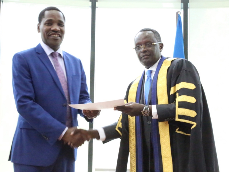 The EALA Speaker, Hon Ngoga K. Martin congratulates Hon Peter Munya upon his swearing in as an ex-officio Member of EALA