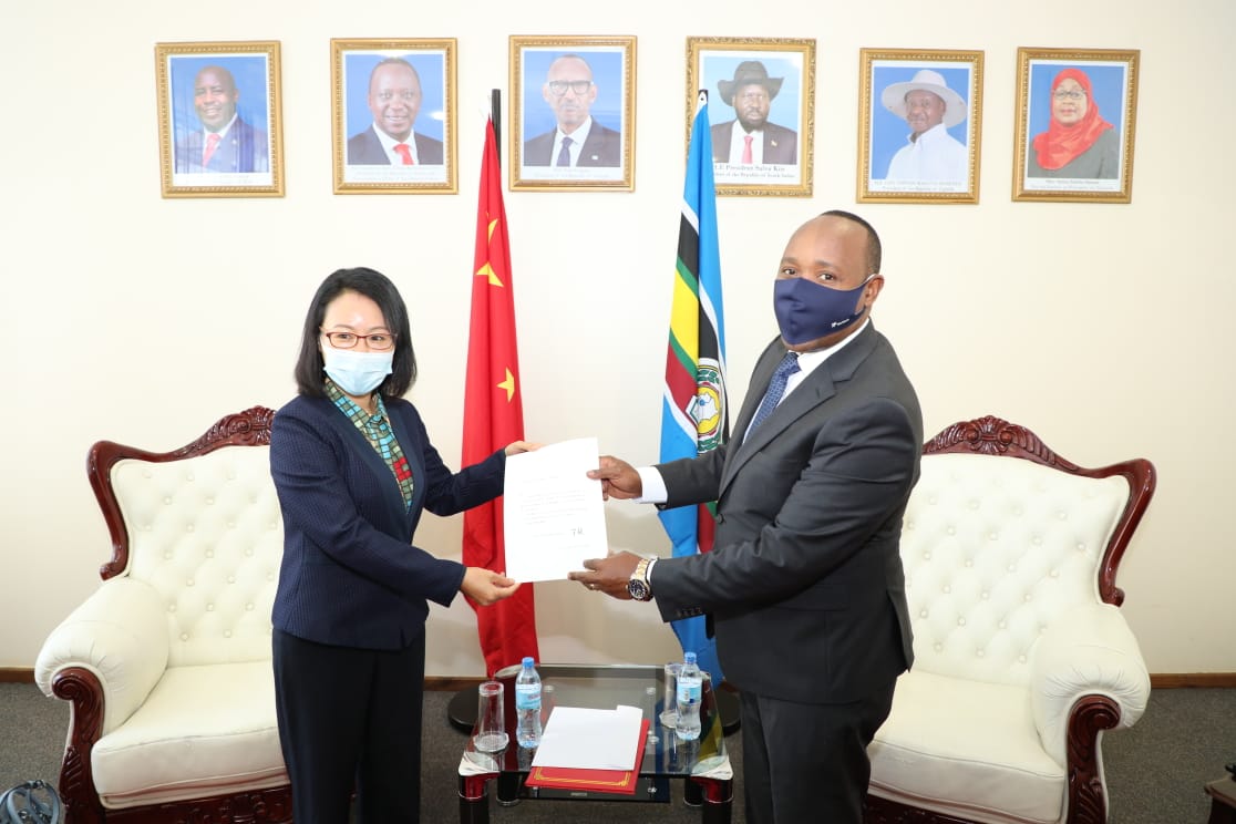 The EAC Secretary General, Hon. (Dr.) Peter Mathuki (right), receives the letter of credence from the Chinese Ambassador to Tanzania and EAC, H.E. Chen Mingjian, at the EAC Headquarters in Arusha, Tanzania.  