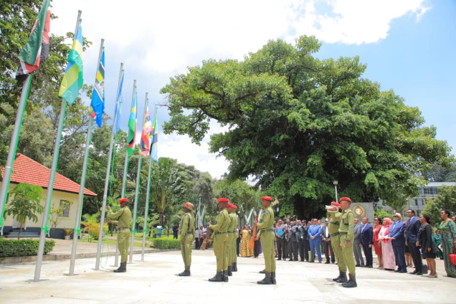 An officer from Tanzania’s Field Force Unit raises the flag of the Federal Republic of Somalia at the EAC Headquarters in Arusha to symbolise Somalia’s entry into the Community as the dignitaries and EAC members of staff look on.