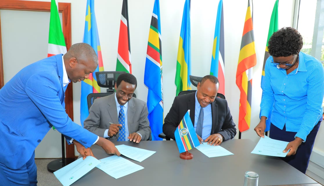 EAC Secretary General Hon. (Dr.) Peter Mathuki and the Managing Director of the Eastern and Southern African Management Institute (ESAMI), Dr. Martin Lwanga, sign the MOU to collaborate on capacity building in regional trade-related issues at the EAC Headquarters in Arusha, Tanzania. 