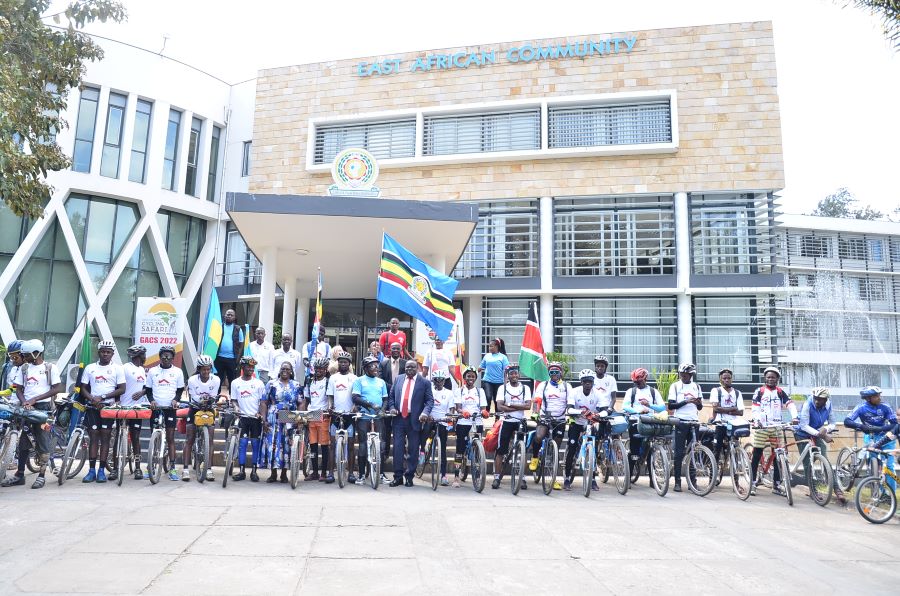 A group opportunity photo of Great African Cycling Safari team  with EAC Deputy Secretary General in charge of the Productive and Social Sectors, Hon. Christophe Bazivamo 