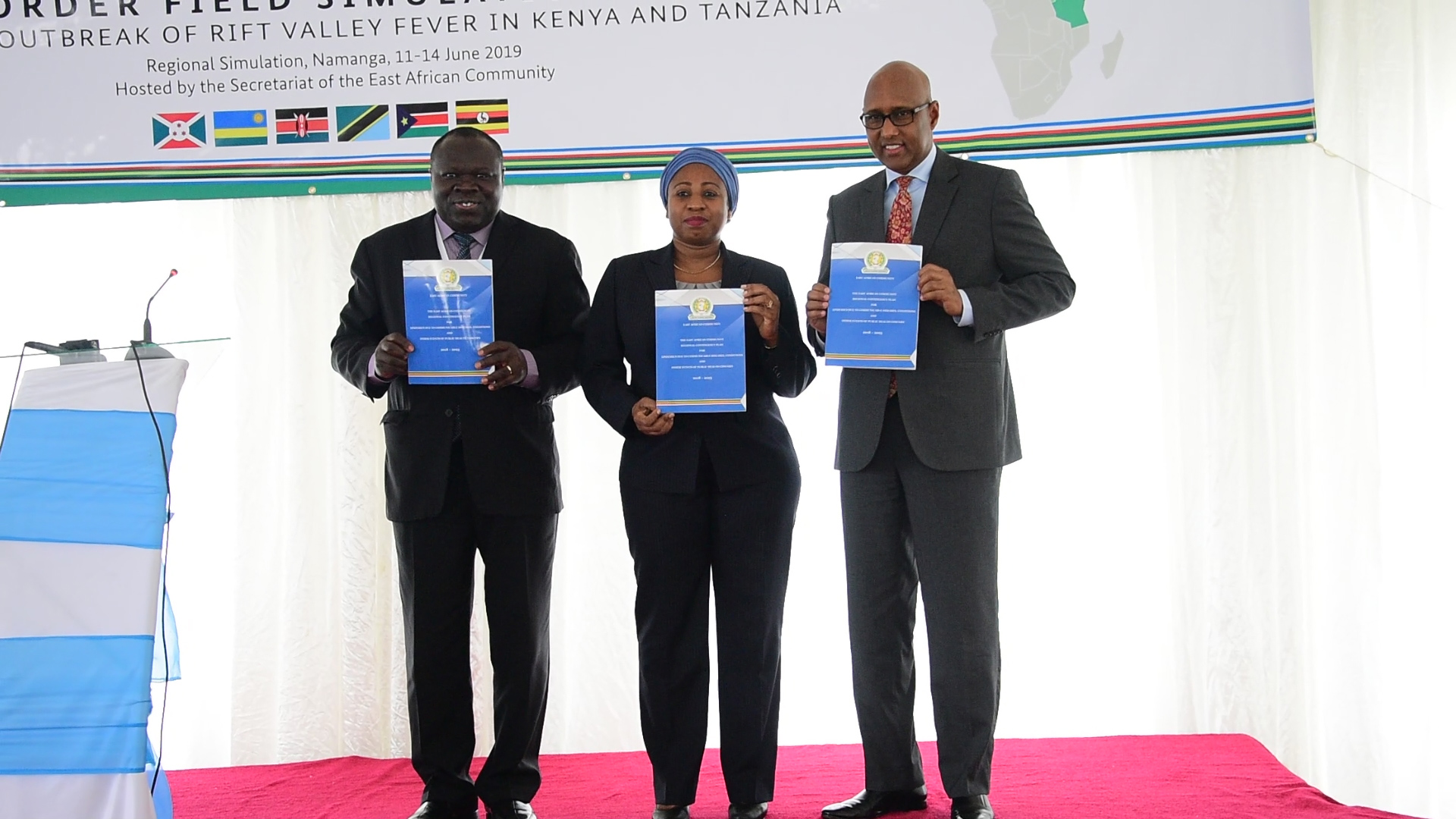 (L-R) EAC Deputy Secretary General, Hon Bazivamo, Minister for Health, Community Development, Gender, Elderly and Children, United Republic of Tanzania Hon Ummy Ali Mwalimu, Adan Abdulla Mohammed, Cabinet Secretary for East African Community & Regional Development –Kenya displaying EAC Contingency Plan 2018-2023 