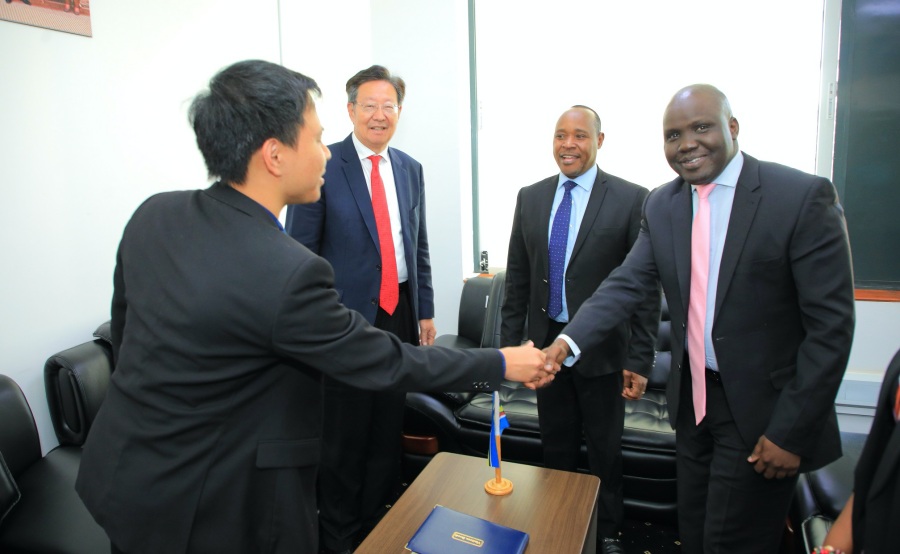 The EAC DSG in charge of Infrastructure, Productive, Social and Politica Sectors, Hon. Andrea Aguer Ariik Malueth (right), greets the CEO of the American Chinese CEOs Society, Mr. Jerry Shang (back to camera) in Arusha. Looking on are the EAC Secretary General Hon. (Dr.) Peter Mathuki (second right) and the President of the American Chinese CEOs Society, Mr. Robert Sun.