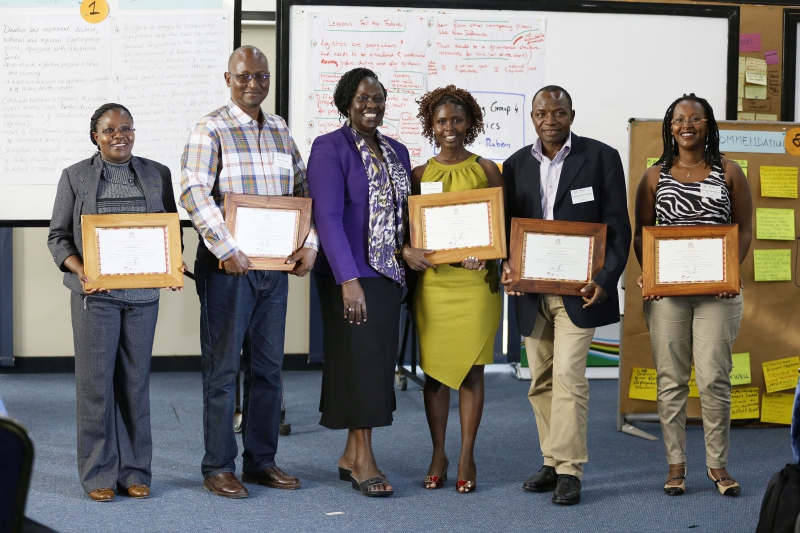 Hon Jesca Eriyo presenting awards to the East African health experts who represented at the conference the round about 500 experts who served in West Africa during the Ebola epidemic (Photo: GIZ/Light in Captivity)