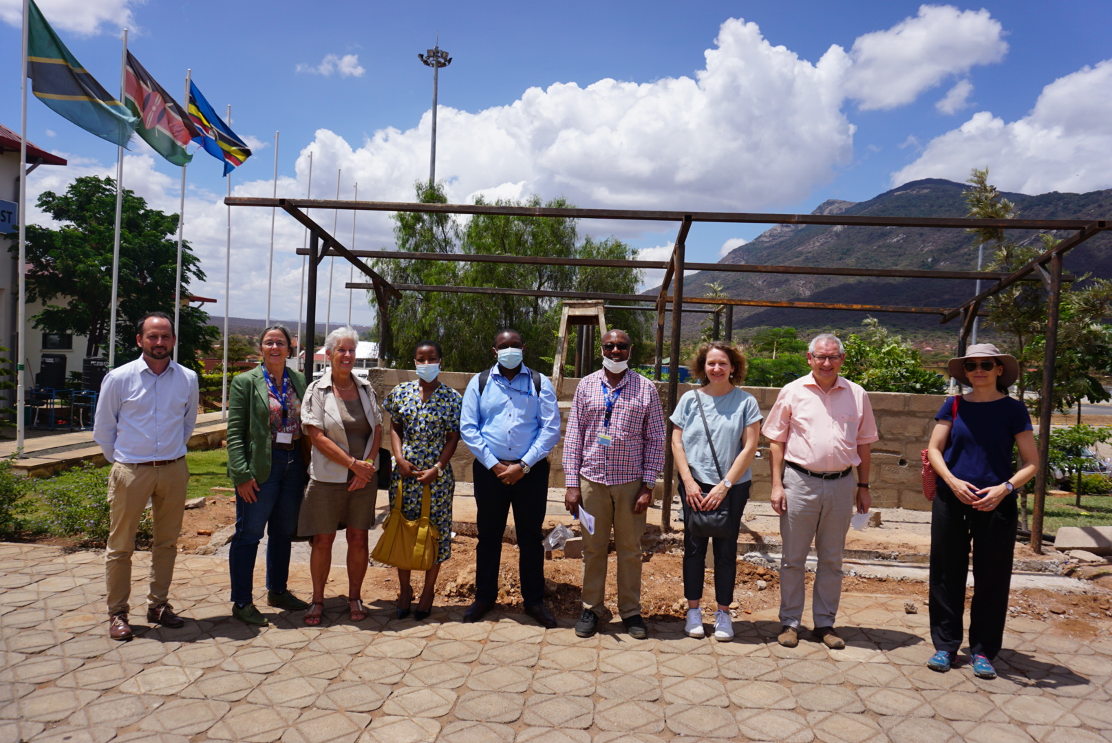 Members of the German delegation, GIZ and IOM staff pose for a photo at the WASH project site in Namanga