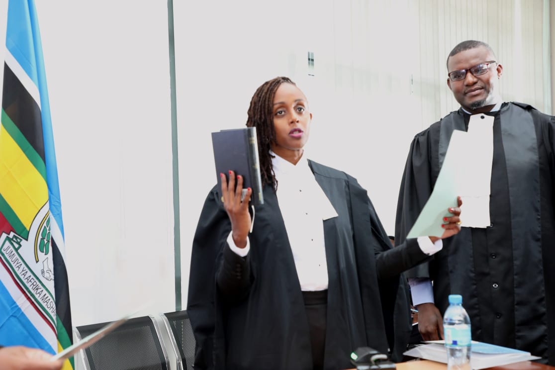 The Principal Legal Officer at the EAC Secretariat, Michel Ndayikengurukiye (right), administers the judicial oath to the newly appointed Deputy Registrar of the East African Court of Justice, Ms. Christine Mutimura-Wekesa on 6th May, 2022 at EAC Headquarters in Arusha.    