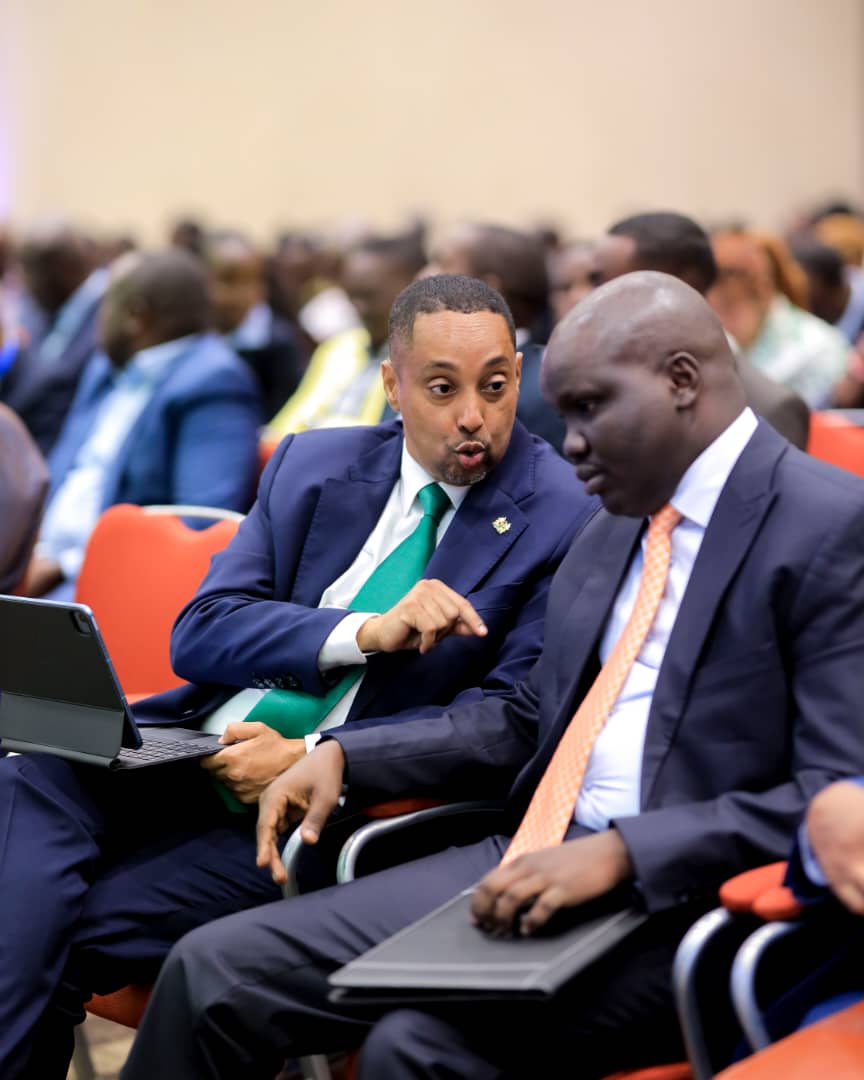 The Principal Secretary in the State Department of EAC, Kenya, Dr. Abdi Dubat Fidhow (left) confers with the EAC Deputy Secretary General in charge of Infrastructure, Productive, Social and Political Sectors, Hon. Andrea Aguer Ariik Malueth during the opening session of the 9th East African Health and Scientific Conference in Kigali.