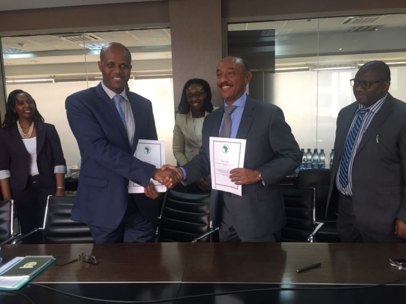The Secretary General of the East African Community, Amb. Liberat Mfumukeko( L) shake hands with Director General of the African Development Bank, East Africa Regional Resource Centre, (EARC), Mr. Gabriel Negatu after the signing ceremony